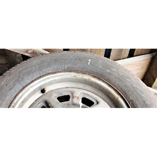 136 - A set of four MGB Rostyles wheels with assorted tyres