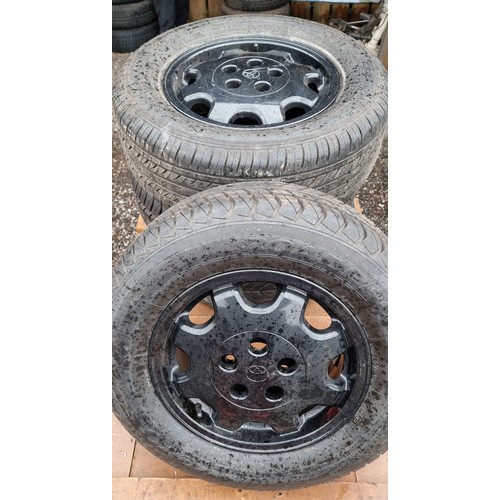 143 - A set of four Toyota Hi Ace wheels and tyres, recently powder coated, as new tyres