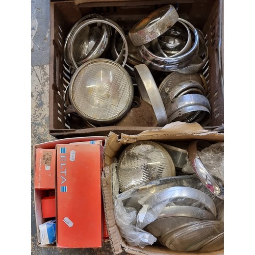 191 - A quantity of British headlamp surrounds, lens and bulbs (2)