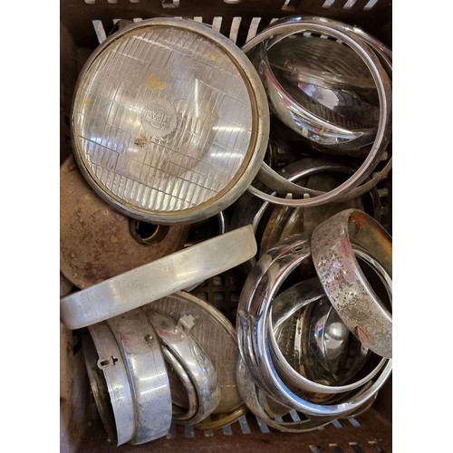 191 - A quantity of British headlamp surrounds, lens and bulbs (2)