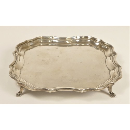 102 - A square silver card tray, by Barker Bros, Chester 1912, raised on four feet, uninscribed, 17ch acro... 