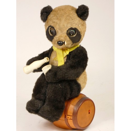 Two drinking panda bear toys, battery operated, picnic bear sat on painted tin log by Alps, Japan c. Two drinking panda bear toys, battery operated, picnic bear sat on painted tin log by Alps, Japan c.