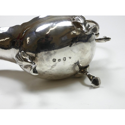 66 - A George III silver sauce boat, makers mark poorly struck, London 1772, with wavy edge and leaf capp... 