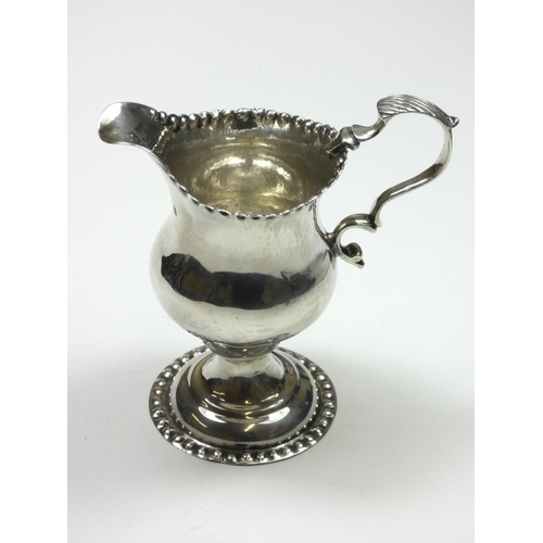 69 - A George III silver baluster cream jug, by Benjamin Bickerton, London 1775, with punched border, lea... 