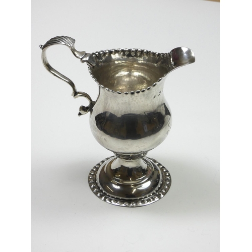 69 - A George III silver baluster cream jug, by Benjamin Bickerton, London 1775, with punched border, lea... 