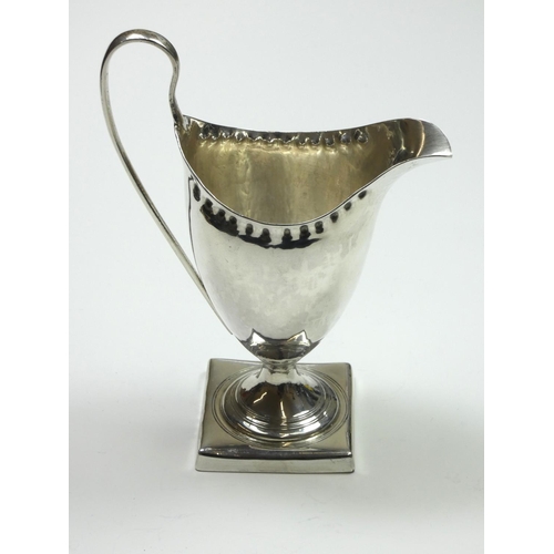 70 - A George III silver baluster cream jug, probably by Albrecht Borchers, London 1792, with punched bor... 