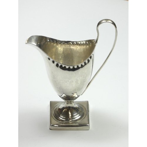 70 - A George III silver baluster cream jug, probably by Albrecht Borchers, London 1792, with punched bor... 