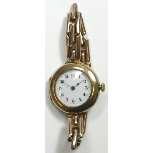 82 - A 9ct rose gold manual wind ladies wristwatch, Birmingham 1919, the white porcelain dial with red 12... 