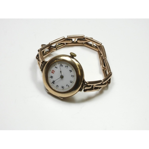 82 - A 9ct rose gold manual wind ladies wristwatch, Birmingham 1919, the white porcelain dial with red 12... 