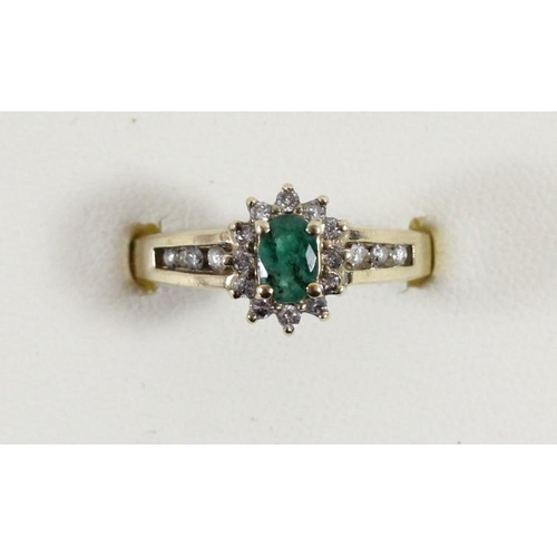 110 - A 10k gold emerald and brilliant cut diamond cluster ring, O 1/2, 3gm