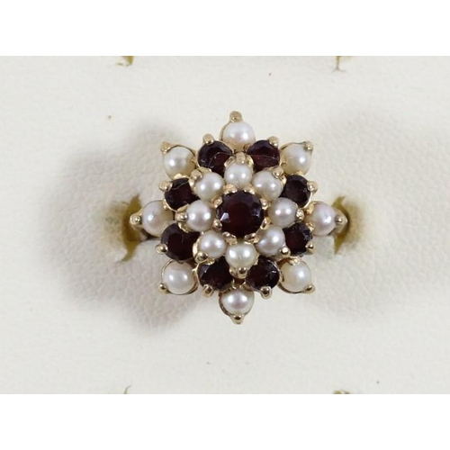 112 - A 9ct gold garnet and pearl cluster ring, O, 4.4gm