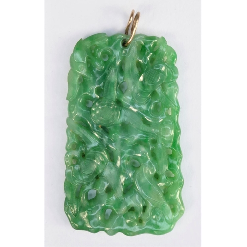 127 - A Chinese green jade pendant, late Qing/Republic period, carved and pierced with birds amongst folia... 