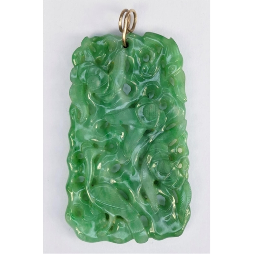 127 - A Chinese green jade pendant, late Qing/Republic period, carved and pierced with birds amongst folia... 