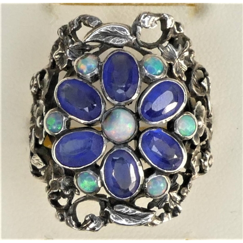 128 - A Birmingham School of Arts & Crafts imitation sapphire and opal (one chipped) silver ring, with flo... 