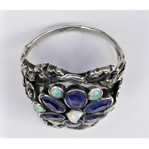 128 - A Birmingham School of Arts & Crafts imitation sapphire and opal (one chipped) silver ring, with flo... 