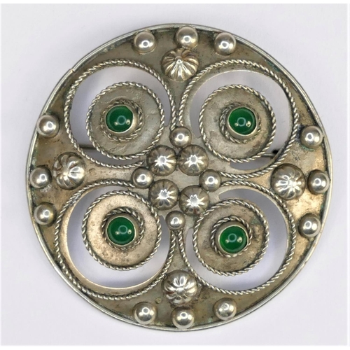 132 - A Scandinavian white metal and stained green chalcedony shield shape brooch, collet set with four ca... 