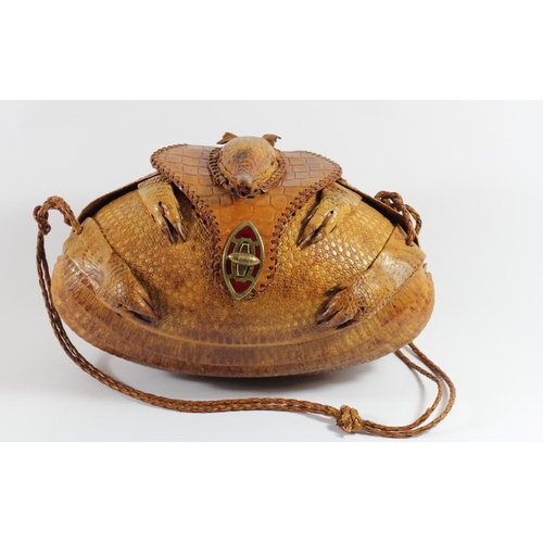 215 - A lady's shoulder bag of rugby ball shape formed from a lined armadillo skin with head and limbs, en... 