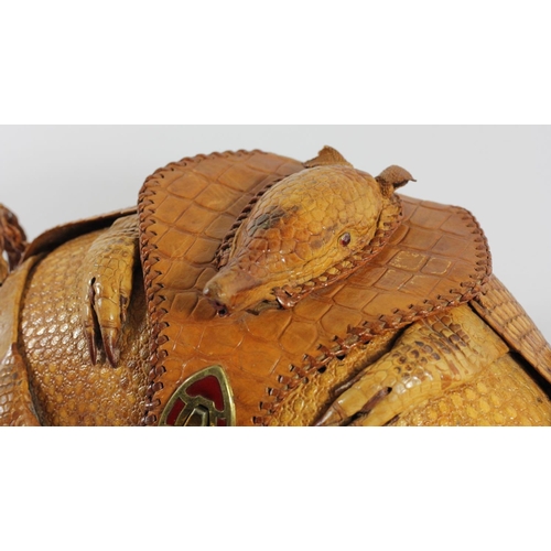 215 - A lady's shoulder bag of rugby ball shape formed from a lined armadillo skin with head and limbs, en... 