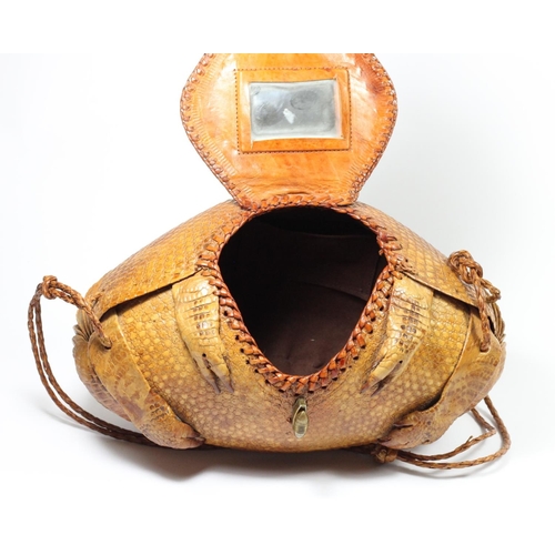 215 - A lady's shoulder bag of rugby ball shape formed from a lined armadillo skin with head and limbs, en... 