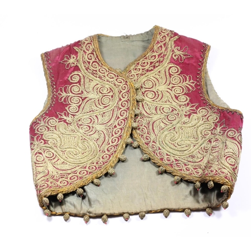 216 - A Georgian red silk and gold wire child's waistcoat, in the Indian taste, with woven ball fringe, 30... 