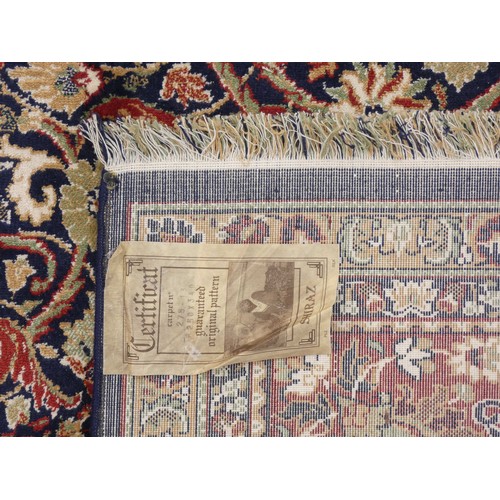 217 - A Shiraz part silk rug, with central floral pendant medallion and spandrels, flowers and trees on a ... 