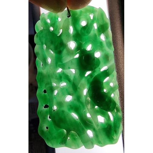 127 - A Chinese green jade pendant, late Qing/Republic period, carved and pierced with birds amongst folia... 