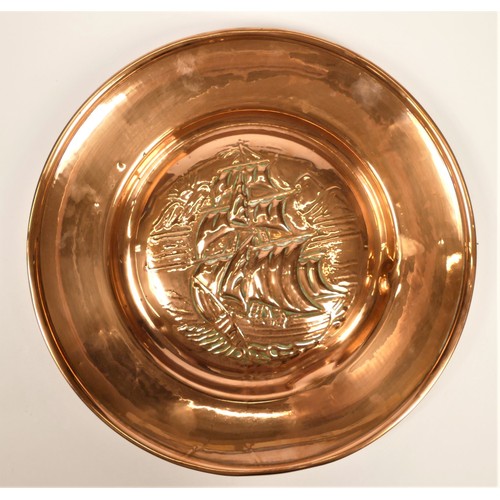 202 - Newlyn School, an Arts and Crafts embossed copper charger, decorated with a galleon, plain fold over... 