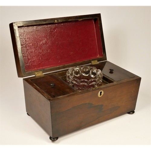 200 - A Regency rosewood tea caddy, the sarcophagus hinged lid opening to reveal a replacement glass mixin... 