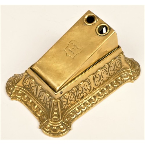 210 - A cast brass cigar cutter, with two cut ting holes, stamped Made in England, 13.5 x 9 x 7cm