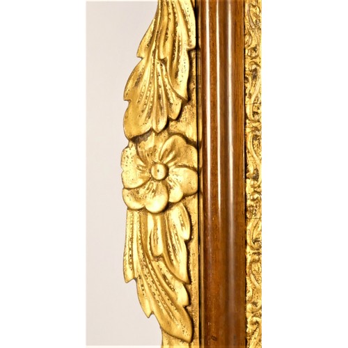 206 - An Edwardian mahogany and gilt wood wall mirror, with eagle surmount and floral border, 105 x 49cm