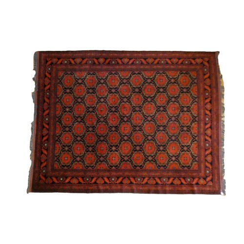 218 - A Turkish woollen Bokhara rug, having a red ground with blue guls, 350 x 250cm