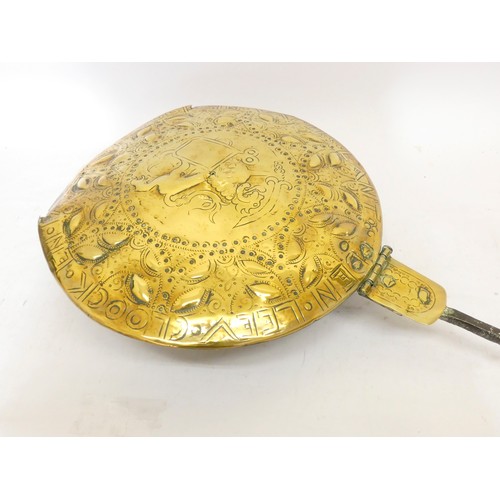 204 - A Dutch 18th century brass warming pan, the embossed domed cover decorated with a pair of lions flan... 