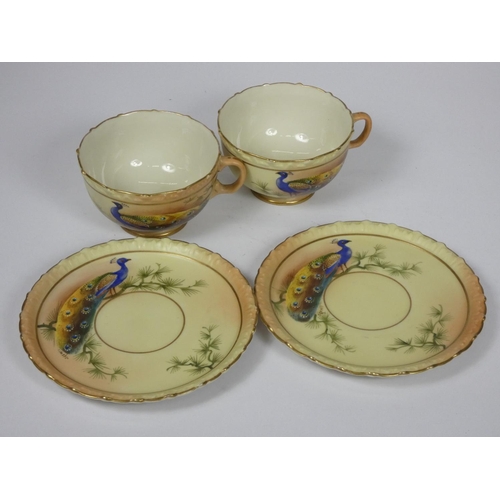 29 - A pair of Locke & Co, Worcester cups and saucers, decorated with peacocks by J. Lewis, pattern 361.