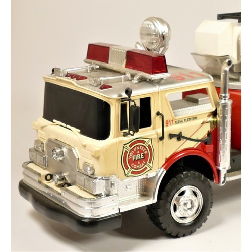 96 - A New Bright remote control fire truck, with extendable ladder and siren