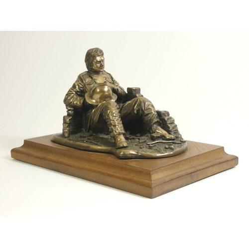 106 - A bronzed figure 'fireman at rest', by A.Miller 1981, signed and dated, on a wooden plinth, together... 