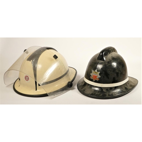 110 - Two South Yorkshire Police helmets, together with two fire helmets, Humberside Fire Brigade, with fi... 