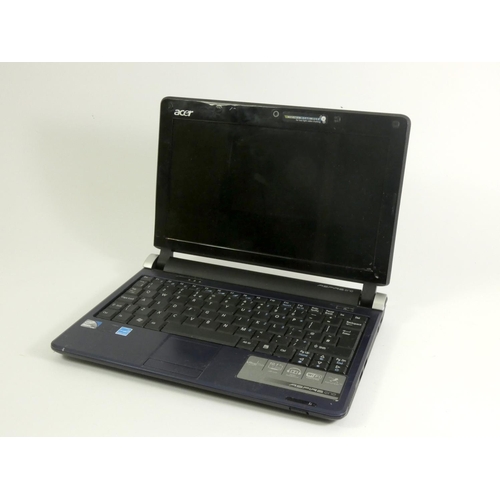 130 - An Acer Apsire one (model no.KAV60) in blue, with charger, VGA and AUX cable, together with an unbra... 