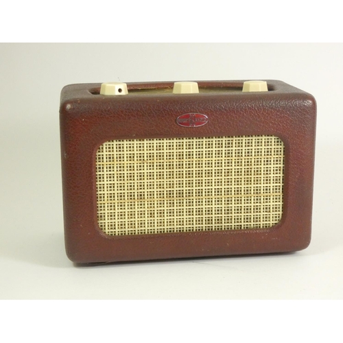 131 - A Roberts Type R55 portable radio, covered in a red leatherette with enamel badge, hinged rear door ... 