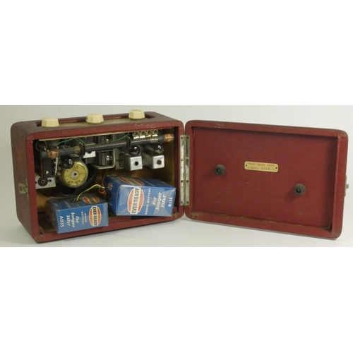 131 - A Roberts Type R55 portable radio, covered in a red leatherette with enamel badge, hinged rear door ... 