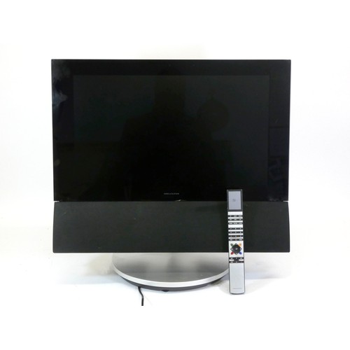 142 - A Bang and Olufsen BeoVision 6 television, with motorised table stand and 22inch screen, including a... 