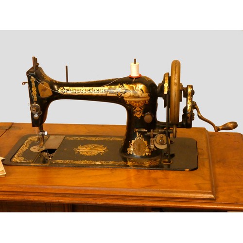 143 - A Singer manual sewing machine (model R1019453), with gilt embossed and painted Egyptian iconography... 