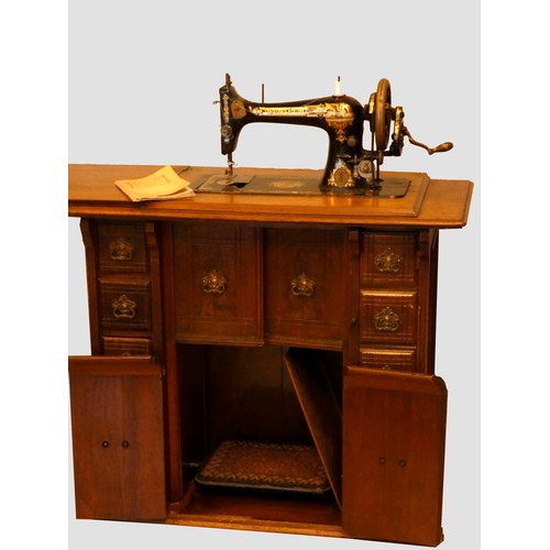 143 - A Singer manual sewing machine (model R1019453), with gilt embossed and painted Egyptian iconography... 