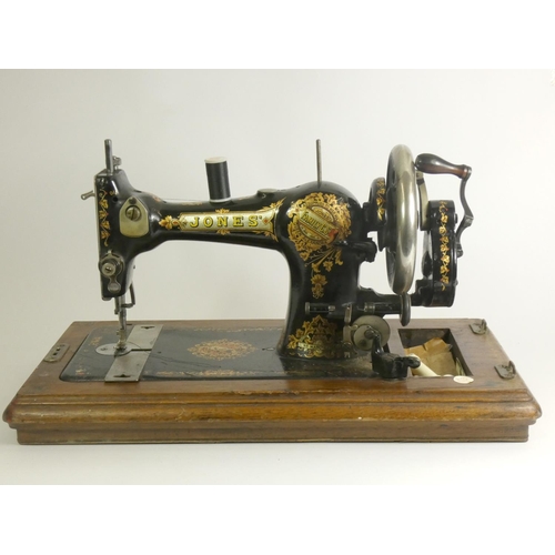 144 - A Jones' manual sewing machine (model 172526), decorated with floral decoration, carry case