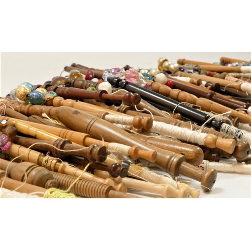 146 - A collection of 131 mainly fruit and hardwood turned bobbins, with spangles, many commemorative, c.1... 