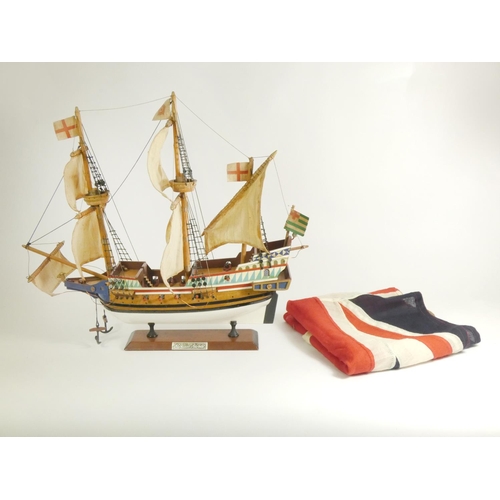 164 - A Golden Hinde model, with fabric rigging and sails, wooden hull and deck, on a plinth with embossed... 