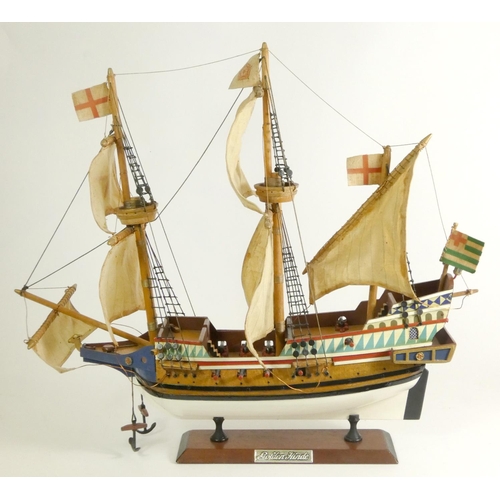 164 - A Golden Hinde model, with fabric rigging and sails, wooden hull and deck, on a plinth with embossed... 