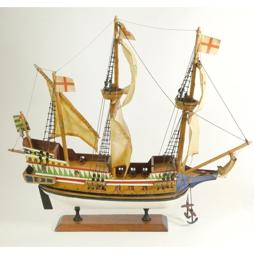 164 - A Golden Hinde model, with fabric rigging and sails, wooden hull and deck, on a plinth with embossed... 