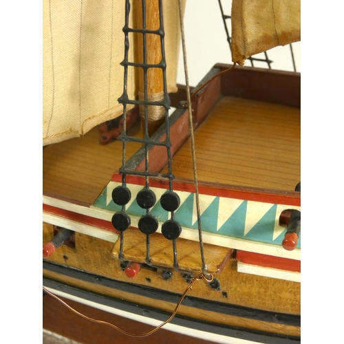 164 - A Golden Hinde model, with fabric rigging and sails, wooden hull and deck, on a plinth with embossed... 