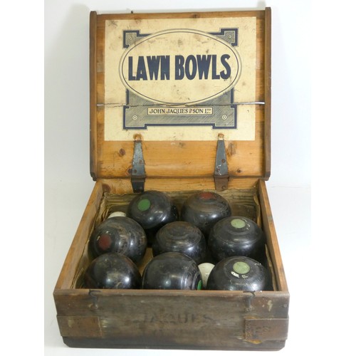 170 - A set of lawn bowls, made by John Jaques & Sons, containing eight bowls and two jacks, branded woode... 