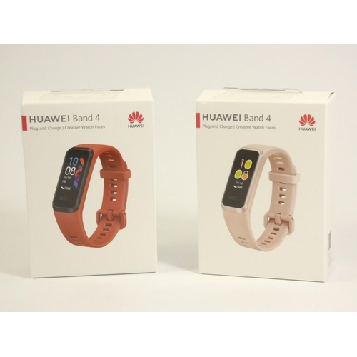 129 - A pair of Huawei band 4 smart watches, in pink and red, original boxes